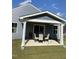 Covered patio with seating area and manicured backyard at 8680 Kenridge Ln, Fuquay Varina, NC 27526