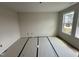 Bright, carpeted bedroom with large windows providing ample natural light at 88 W Emily Gardens Dr, Selma, NC 27576