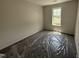 A bright carpeted bedroom offering natural light at 88 W Emily Gardens Dr, Selma, NC 27576