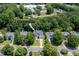 Aerial view of a beautiful home at 8828 Deerland Grove nestled among lush trees in a tranquil neighborhood at 8828 Deerland Grove Dr, Raleigh, NC 27615