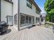 Large home backyard with a wood deck perfect for entertaining and relaxation at 8828 Deerland Grove Dr, Raleigh, NC 27615