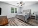 Comfortable bedroom featuring stylish wood-look flooring and a ceiling fan for added comfort at 8828 Deerland Grove Dr, Raleigh, NC 27615
