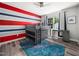Fun bedroom boasting unique painted stripes, modern ceiling fan, and a cool bunk bed at 8828 Deerland Grove Dr, Raleigh, NC 27615