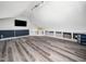 Spacious bonus room featuring modern lighting, built-in shelving, and plenty of open space at 8828 Deerland Grove Dr, Raleigh, NC 27615