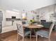 Open concept breakfast nook and living space combination features hardwood floors and neutral tones at 8828 Deerland Grove Dr, Raleigh, NC 27615
