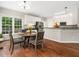 Charming breakfast nook with hardwood floors and large windows offers ample natural light and table seating at 8828 Deerland Grove Dr, Raleigh, NC 27615