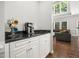Inviting coffee bar area with a black countertop and a coffee maker and colorful mugs hanging nearby at 8828 Deerland Grove Dr, Raleigh, NC 27615