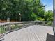 Relaxing wood deck with lush green surroundings for outdoor enjoyment and peaceful relaxation at 8828 Deerland Grove Dr, Raleigh, NC 27615