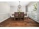 Elegant dining room featuring a chandelier, hardwood floors, and an open layout at 8828 Deerland Grove Dr, Raleigh, NC 27615