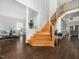 Spacious foyer featuring a grand staircase, hardwood floors, and abundant natural light at 8828 Deerland Grove Dr, Raleigh, NC 27615