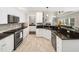 Spacious kitchen with tile floors, granite countertops, and white cabinets provides a functional cooking space at 8828 Deerland Grove Dr, Raleigh, NC 27615