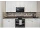 Close up on kitchen detailing the backsplash and new appliances at 8828 Deerland Grove Dr, Raleigh, NC 27615