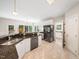 Open kitchen featuring granite counters, stainless steel appliances, and light tile floors leads to breakfast nook at 8828 Deerland Grove Dr, Raleigh, NC 27615