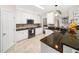 Well-lit kitchen with tile floors, granite countertops, and white cabinets offers a functional space at 8828 Deerland Grove Dr, Raleigh, NC 27615