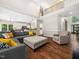 Open-concept living room with vaulted ceilings and hardwood flooring provides an airy, spacious feel at 8828 Deerland Grove Dr, Raleigh, NC 27615