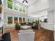 Spacious living room with vaulted ceilings, large windows, and hardwood flooring offers ample natural light at 8828 Deerland Grove Dr, Raleigh, NC 27615