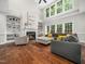 Inviting living room with a fireplace, built-in shelves, and abundant natural light at 8828 Deerland Grove Dr, Raleigh, NC 27615