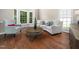 Bright living room featuring hardwood floors, stylish furnishings, and an open floor plan at 8828 Deerland Grove Dr, Raleigh, NC 27615