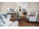 Bright living room featuring hardwood floors, stylish furnishings, and an open floor plan at 8828 Deerland Grove Dr, Raleigh, NC 27615