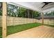 A covered porch with a ceiling fan overlooking a large, fenced-in yard at 905 Deboy St, Raleigh, NC 27606