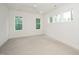 Empty bedroom with ample natural light, ceiling fan, and neutral carpet at 905 Deboy St, Raleigh, NC 27606