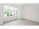Bright bedroom with three large windows overlooking the lush backyard at 905 Deboy St, Raleigh, NC 27606