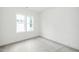 A bright bedroom with three large windows, carpet, and neutral walls at 905 Deboy St, Raleigh, NC 27606