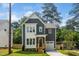 Charming two-story home with gray siding, white trim, a covered porch, and a well-maintained lawn at 905 Deboy St, Raleigh, NC 27606