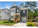 Charming two-story home with a gray exterior, white trim, covered porch, and well-manicured lawn at 905 Deboy St, Raleigh, NC 27606