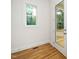 Bright interior room with hardwood floors, a window with a view, and a glass door to the outside at 905 Deboy St, Raleigh, NC 27606