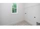 Laundry room with patterned tile floor and a window at 905 Deboy St, Raleigh, NC 27606