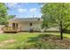 Backyard with lush green lawn, mature shade trees and wood deck at 9709 Batesville Dr, Raleigh, NC 27617