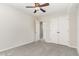 A view of the plush carpeted bedroom showcasing an open doorway at 9709 Batesville Dr, Raleigh, NC 27617