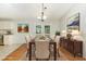 Elegant dining room with a wooden table, seating for six, and French doors to the backyard at 9709 Batesville Dr, Raleigh, NC 27617