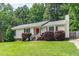 Charming single-story home with a well-maintained lawn, red front door and manicured shrubbery at 9709 Batesville Dr, Raleigh, NC 27617