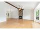 Bright and airy living room with a stone fireplace, hardwood floors, and vaulted ceiling at 9709 Batesville Dr, Raleigh, NC 27617