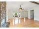 Spacious living room featuring hardwood floors, a stone fireplace, and large bay window at 9709 Batesville Dr, Raleigh, NC 27617