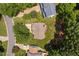 Aerial view of a charming home with a well-maintained lawn and mature trees at 9728 Batesville Dr, Raleigh, NC 27617