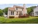 Home's backyard featuring a deck and lush green lawn at 9728 Batesville Dr, Raleigh, NC 27617