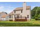 Home's backyard featuring a deck and lush green lawn at 9728 Batesville Dr, Raleigh, NC 27617