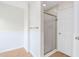 Bathroom featuring walk-in shower with glass door and linen closet at 9728 Batesville Dr, Raleigh, NC 27617