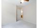 Carpeted bedroom with ceiling fan and view into bathroom at 9728 Batesville Dr, Raleigh, NC 27617
