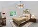 Cozy bedroom with neutral tones, complemented by a ceiling fan, creating a peaceful retreat at 9728 Batesville Dr, Raleigh, NC 27617