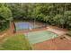 An aerial view of the community's tennis, basketball and pickleball courts surrounded by lush trees at 9728 Batesville Dr, Raleigh, NC 27617