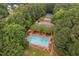 Aerial view of a community pool and tennis courts surrounded by lush greenery at 9728 Batesville Dr, Raleigh, NC 27617