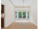 Bright dining room featuring large windows and neutral walls at 9728 Batesville Dr, Raleigh, NC 27617