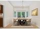 Bright dining room featuring large windows, a modern chandelier, and ample seating at 9728 Batesville Dr, Raleigh, NC 27617