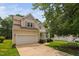 Charming two-story home with a well-maintained lawn and attached two-car garage at 9728 Batesville Dr, Raleigh, NC 27617