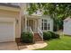 Inviting home entrance with brick steps, white railings, and manicured landscaping at 9728 Batesville Dr, Raleigh, NC 27617