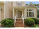 Charming home entrance features brick steps, white railings and tidy shrubbery at 9728 Batesville Dr, Raleigh, NC 27617